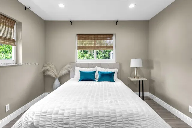 a bed sitting in a bedroom next to a window