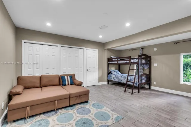 a bedroom with furniture and a window