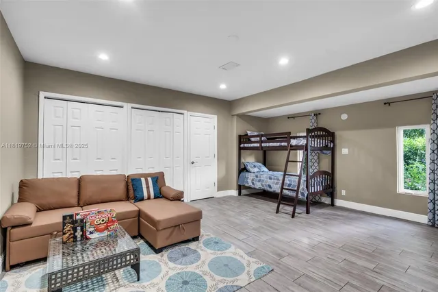 a bedroom with furniture and a book shelf