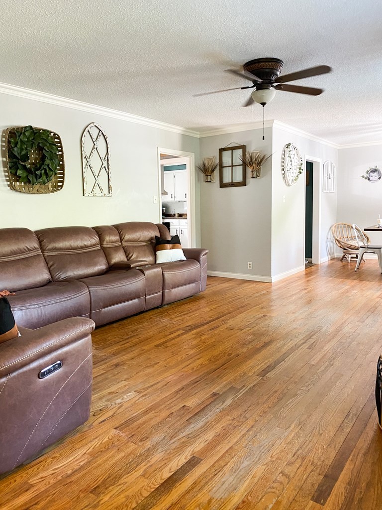 173 Magnolia Street Camden, TN 38320 - Photo 11 of 22 a living room with furniture and a wooden floor