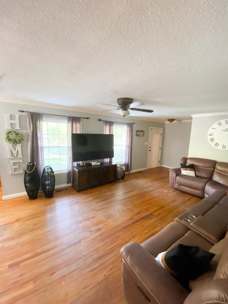 173 Magnolia Street Camden, TN 38320 - Photo 12 of 22 a living room with furniture and a flat screen tv
