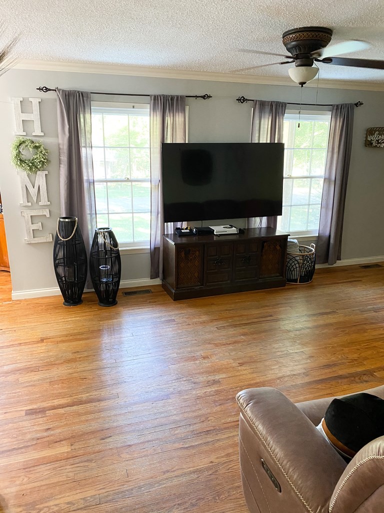 173 Magnolia Street Camden, TN 38320 - Photo 15 of 22 a living room with furniture and a flat screen tv