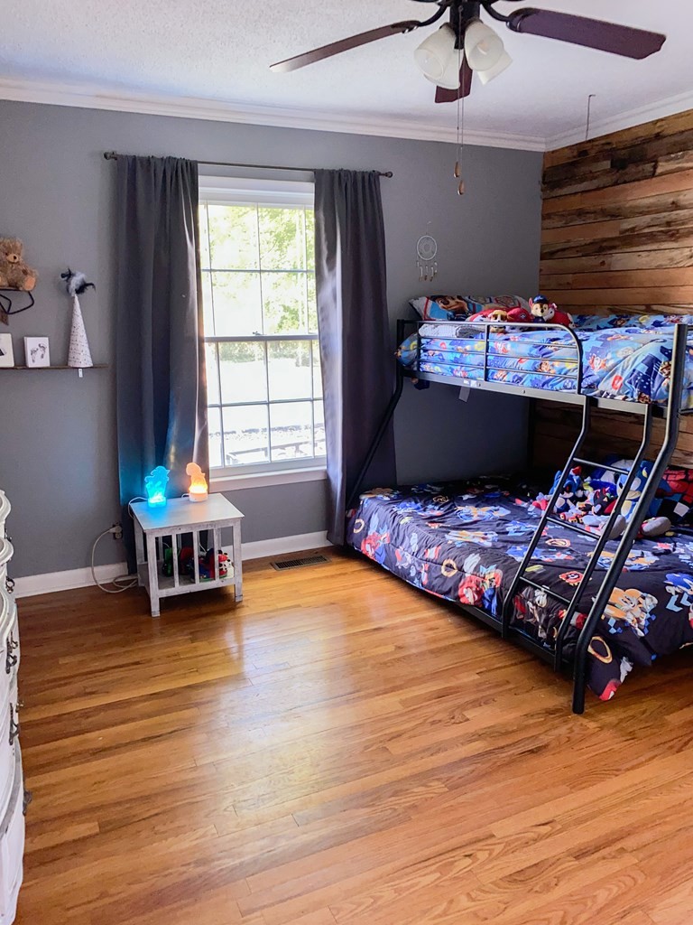 173 Magnolia Street Camden, TN 38320 - Photo 16 of 22 a bedroom with a bed and a window