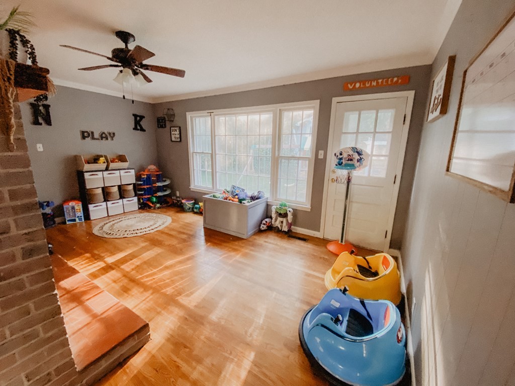 173 Magnolia Street Camden, TN 38320 - Photo 17 of 22 a living room with furniture and a floor to ceiling window