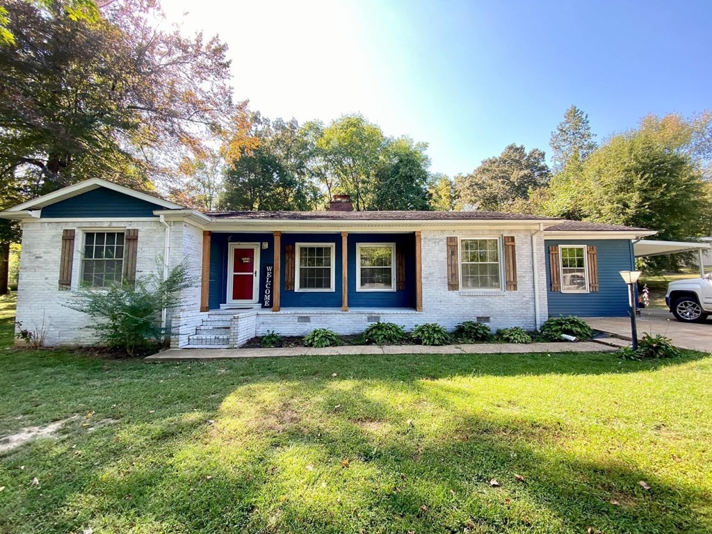 173 Magnolia Street Camden, TN 38320 - Photo 22 of 22 a view of a house with a yard and plants