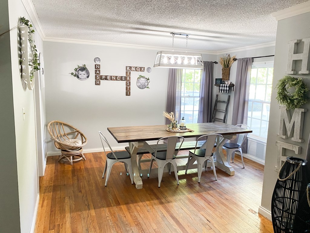 173 Magnolia Street Camden, TN 38320 - Photo 5 of 22 a view of a dining room with furniture and wooden floor