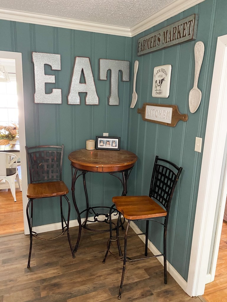 173 Magnolia Street Camden, TN 38320 - Photo 6 of 22 a view of a dining room with furniture and wooden floor
