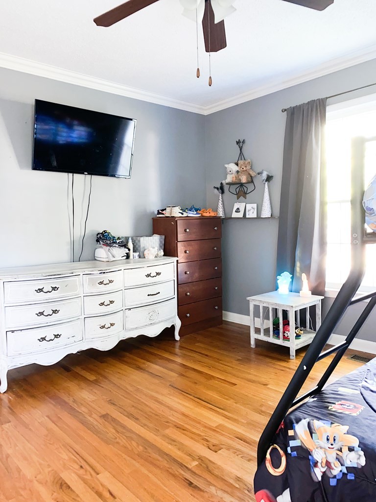 173 Magnolia Street Camden, TN 38320 - Photo 8 of 22 a bedroom with furniture and a flat screen tv