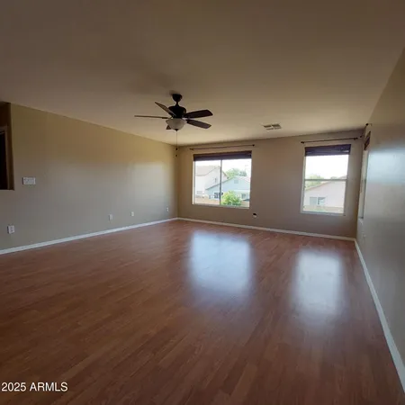 a view of wooden floor and windows in a room