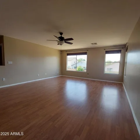 a view of wooden floor and windows in a room
