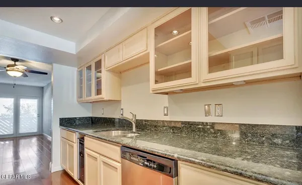 a kitchen with stainless steel appliances granite countertop a sink stove and cabinets