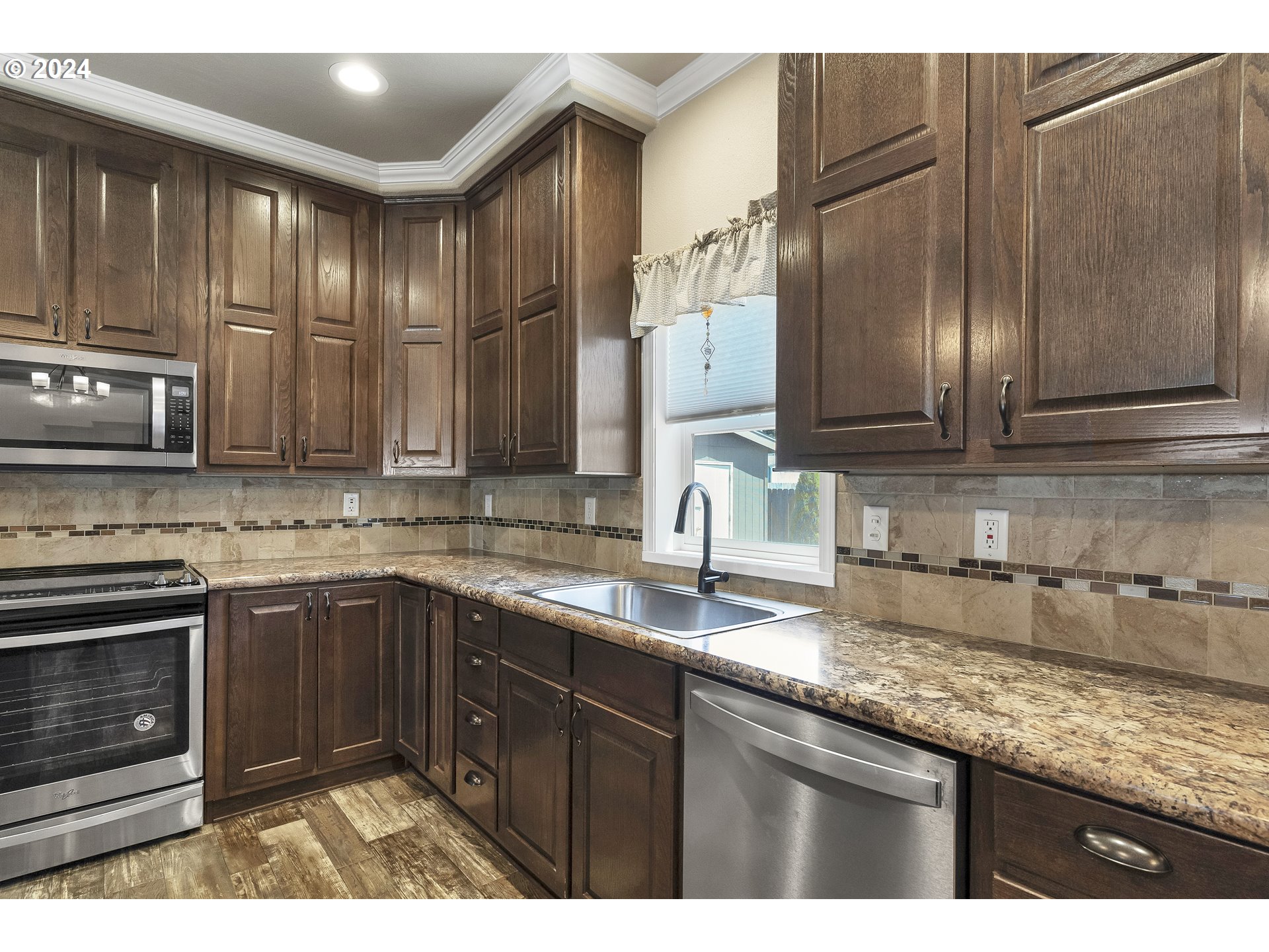 610 Vaughan Lane Lebanon, OR 97355 - Photo 12 of 35 a kitchen with stainless steel appliances granite countertop a sink stove and microwave