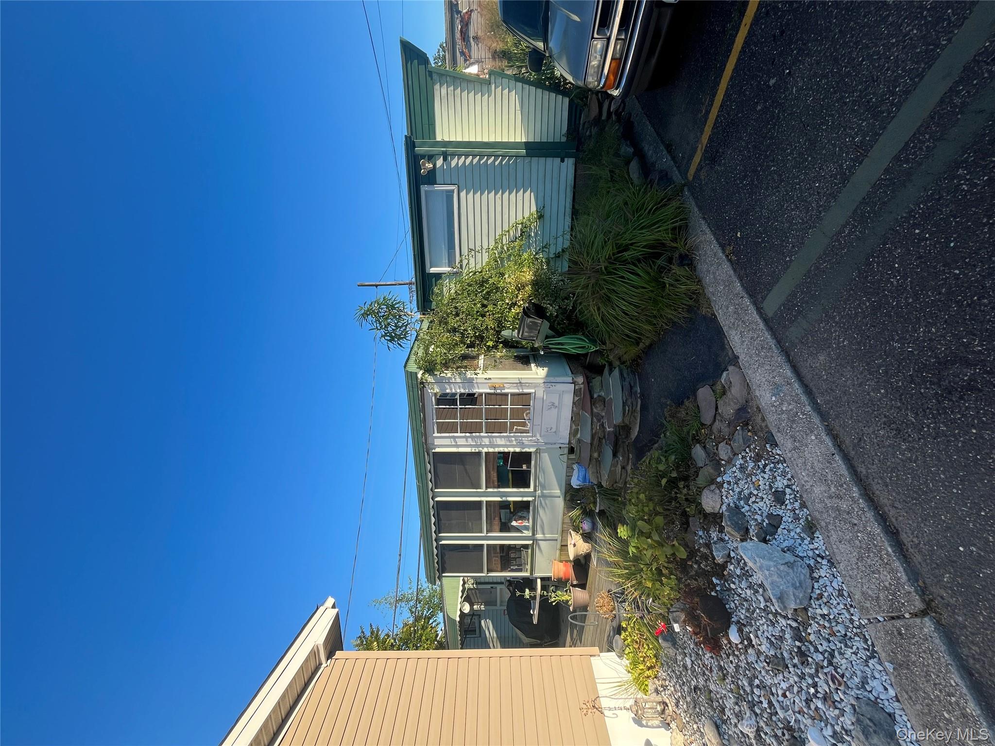 150 Main Street, Unit 32 Islip, NY 11751 - Photo 2 of 3 a view of a house with backyard and garden