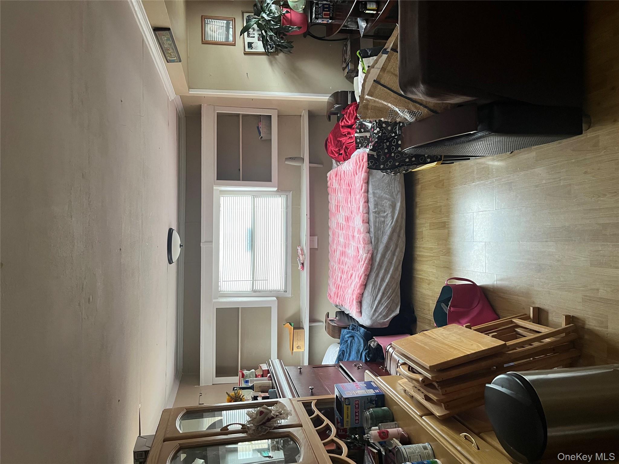 150 Main Street, Unit 32 Islip, NY 11751 - Photo 4 of 5 a bedroom with a bed and furniture
