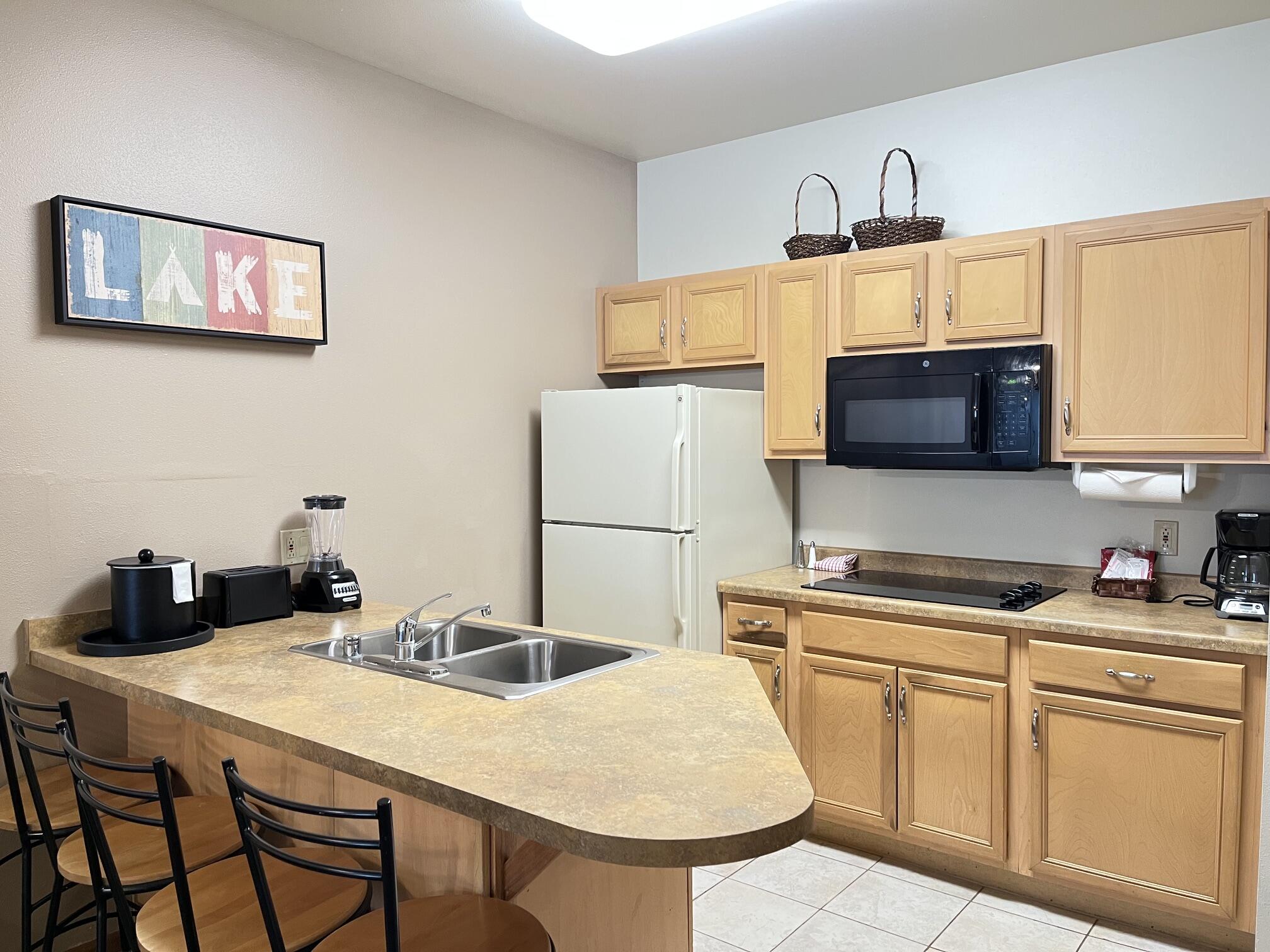 Undisclosed Address Lyons, WI 53147 - Photo 5 of 17 Ceramic tile. Refrigerator, cooktop, microwave & dishwasher included along with all kitchenware. Island with 3 chairs. Dinette area with table not pictured to the left.