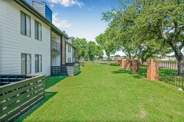 a view of a backyard with wooden fence