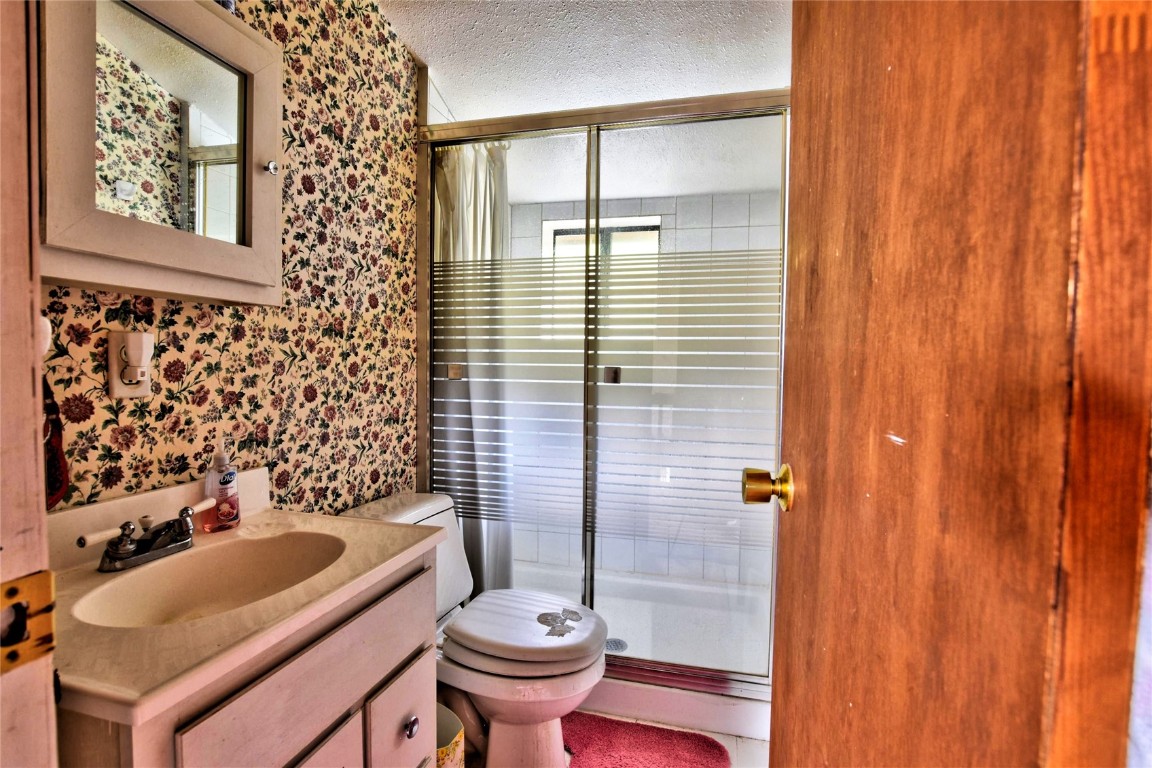 1722 Stagestop Road Jefferson, CO 80456 - Photo 11 of 25 a bathroom with a sink a toilet and shower