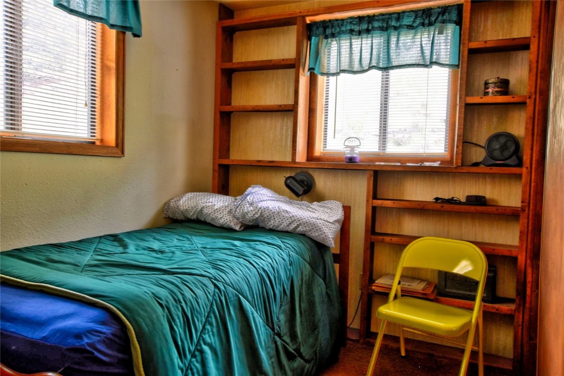 1722 Stagestop Road Jefferson, CO 80456 - Photo 15 of 25 a bedroom with a bed and windows