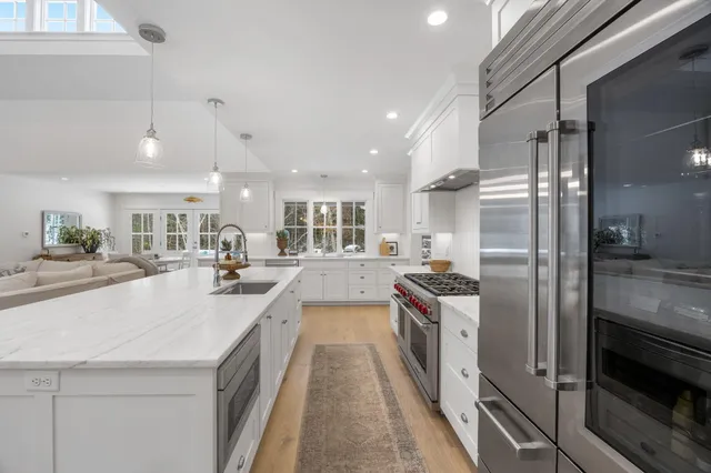a large kitchen with a large counter top appliances and cabinets