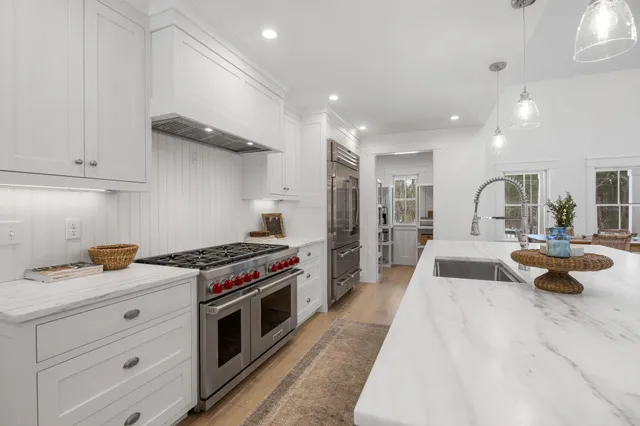 a kitchen with sink stove and cabinets