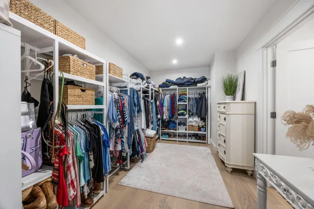 a view of a room with furniture and wooden floor