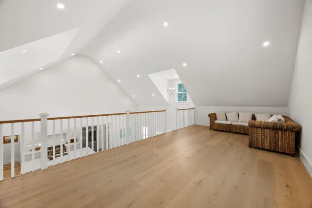 a living room with furniture and view of kitchen