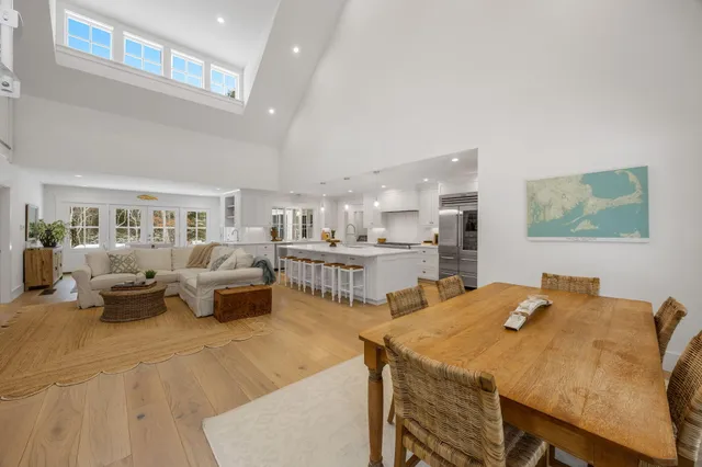 a living room with furniture and a view of kitchen