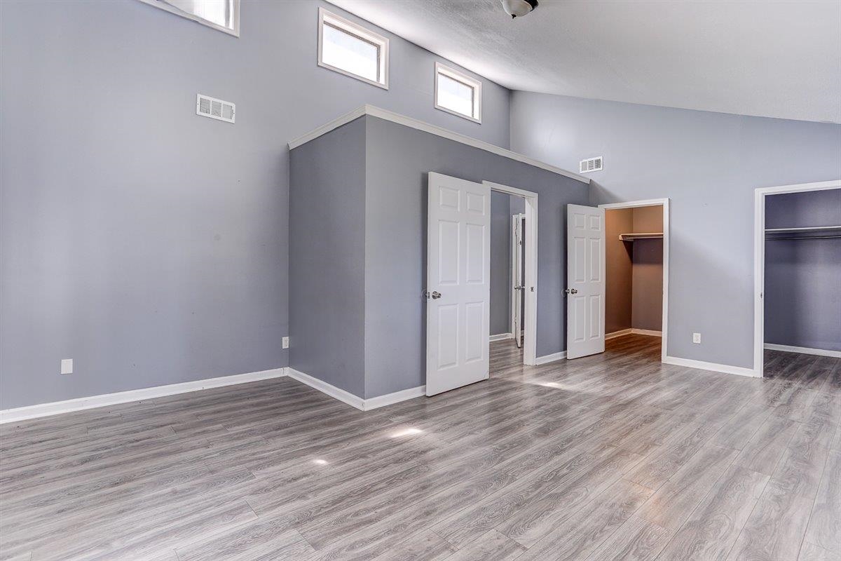 3700 Lakeview Road Memphis, TN 38116 - Photo 37 of 40 Unfurnished bedroom featuring high vaulted ceiling, a spacious closet, and wood finished floors