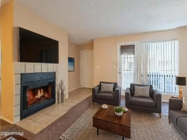 a living room with furniture a flat screen tv and a fireplace