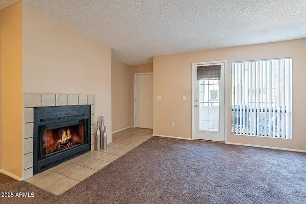 a view of an empty room with a fireplace