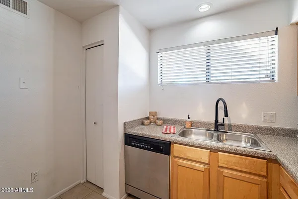 a kitchen with a sink and a wooden floor