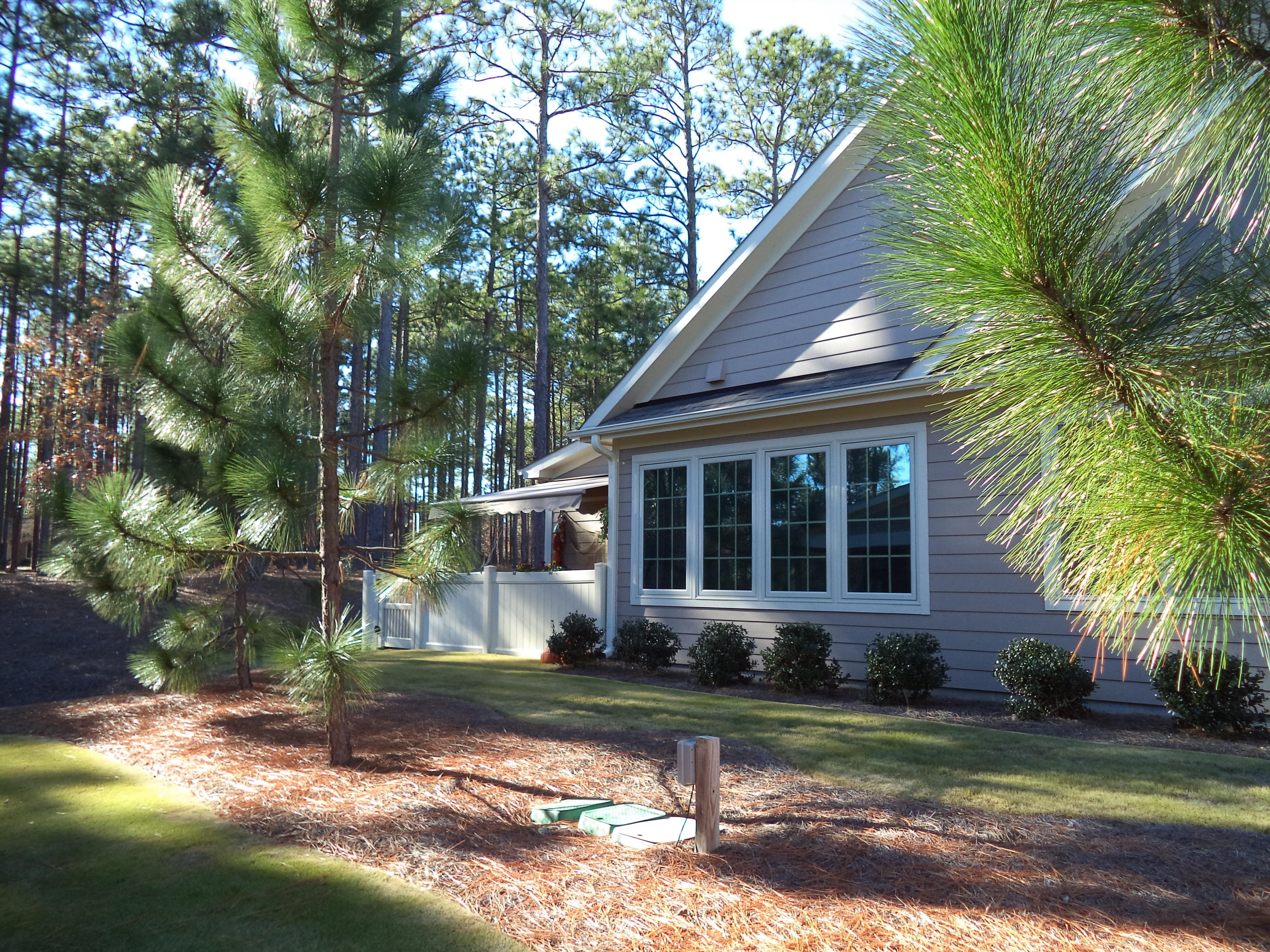 The back corner boasts a bright Carolina room adjacent to the fenced patio