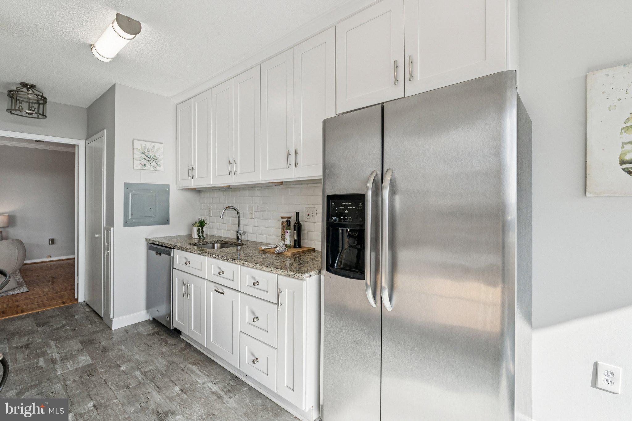 400 Madison Street, Unit 603 Alexandria, VA 22314 - Photo 11 of 46 a kitchen with a refrigerator a sink and cabinets