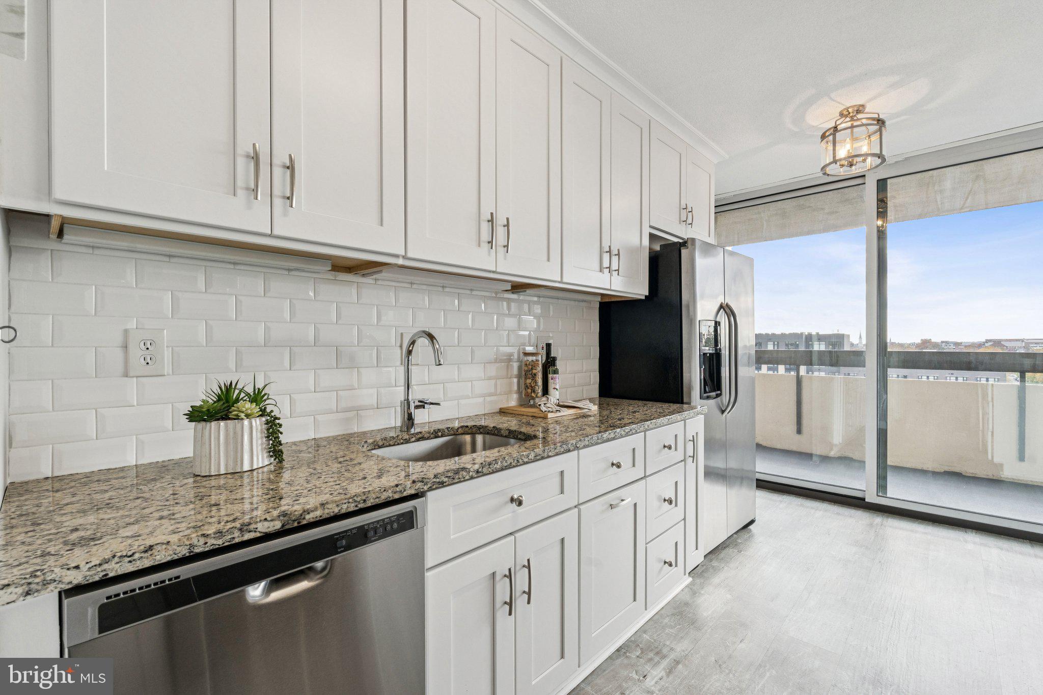 400 Madison Street, Unit 603 Alexandria, VA 22314 - Photo 12 of 46 a kitchen with white cabinets and a sink
