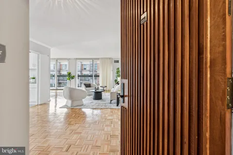 a living room with furniture and a book shelf