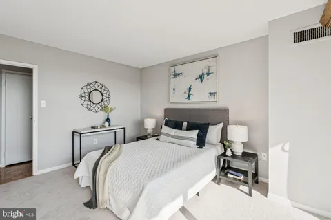 a bathroom with a bathtub shower sink vanity and toilet