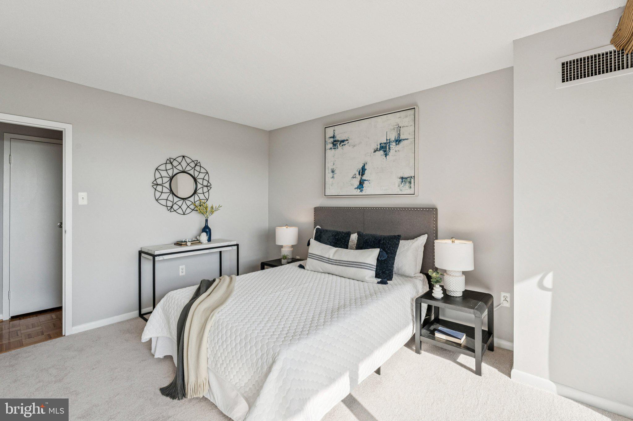 400 Madison Street, Unit 603 Alexandria, VA 22314 - Photo 25 of 46 a bedroom with a bed and a table