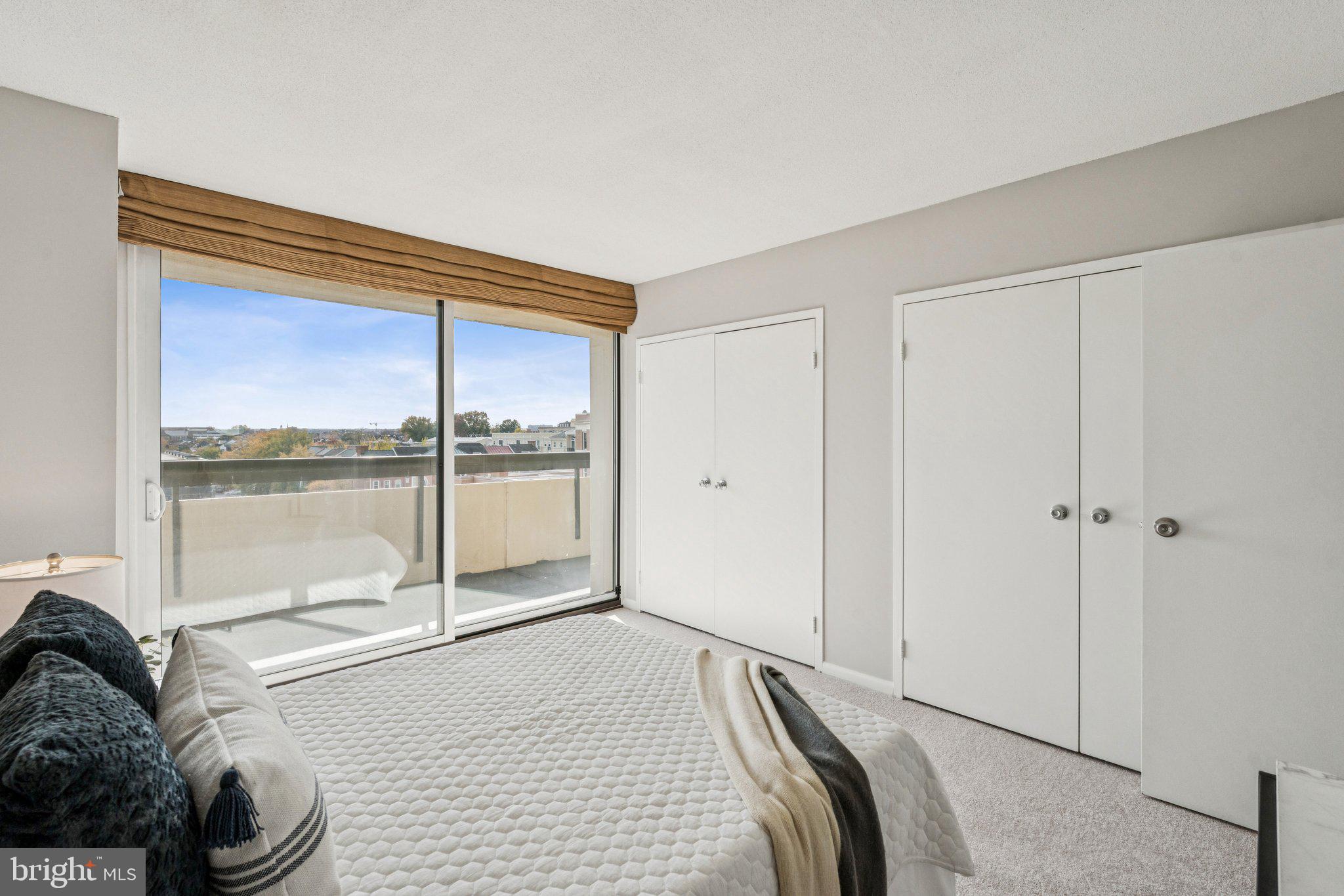 400 Madison Street, Unit 603 Alexandria, VA 22314 - Photo 26 of 46 a bedroom with a bed and with large windows