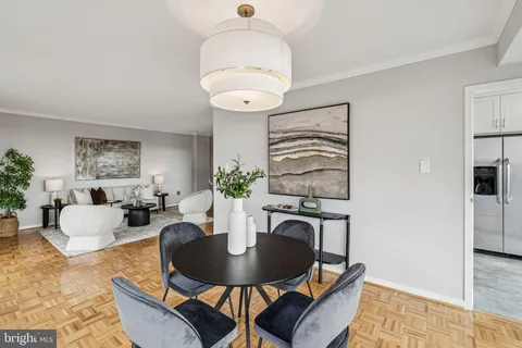 a living room with furniture a rug and a chandelier