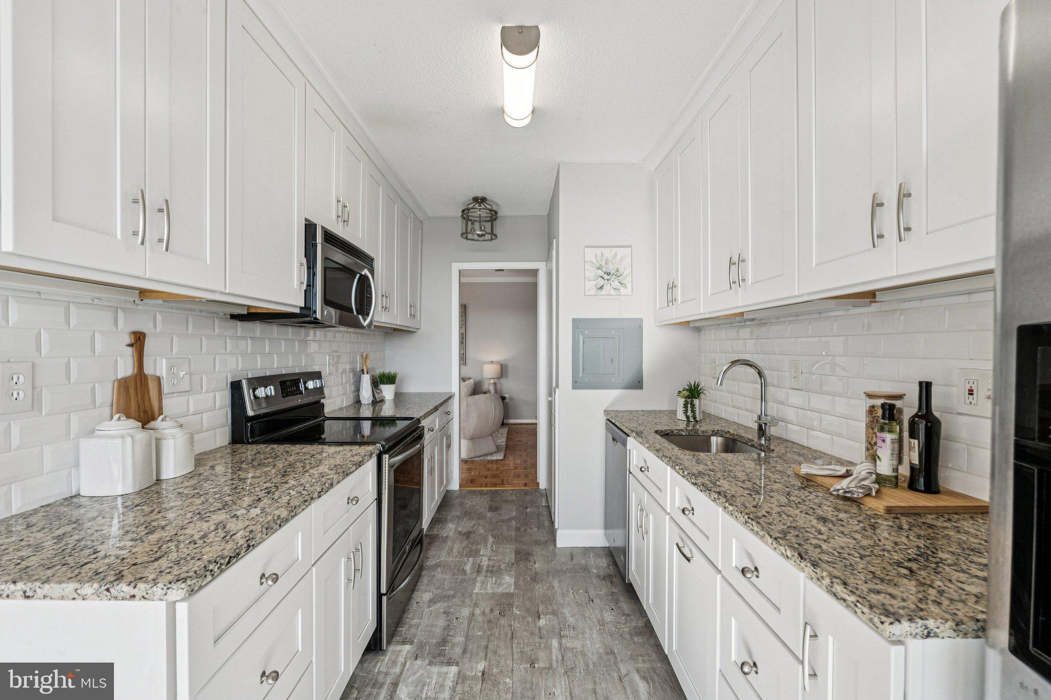 400 Madison Street, Unit 603 Alexandria, VA 22314 - Photo 10 of 46 a kitchen with stainless steel appliances granite countertop a sink stove and refrigerator
