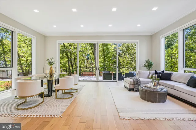 a living room with furniture and large windows