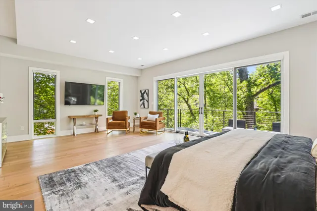 a bed room with a bed and large windows
