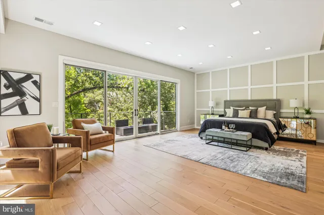 a bedroom with a bed and glass window