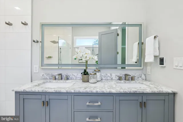 a bathroom with double sink and a mirror