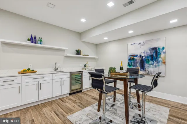 a view of kitchen with cabinets and wooden floor