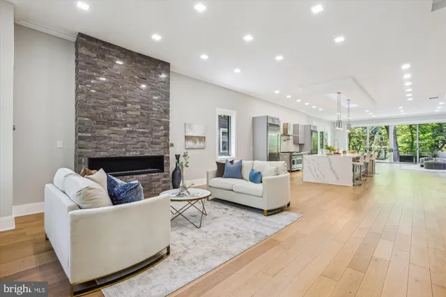 a living room with fireplace furniture and a wooden floor