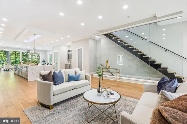a living room with furniture and a dining table with kitchen view
