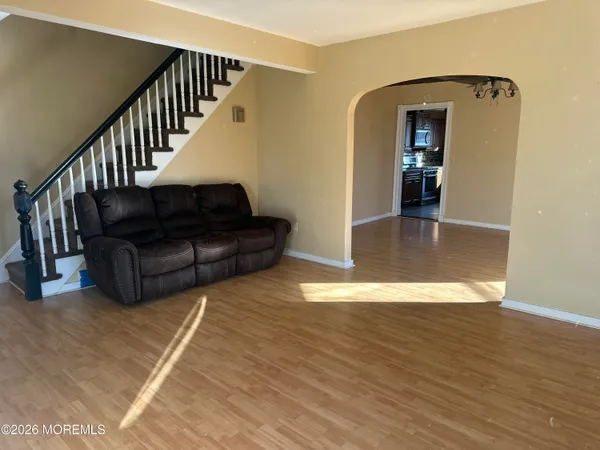 a living room with furniture and wooden floor