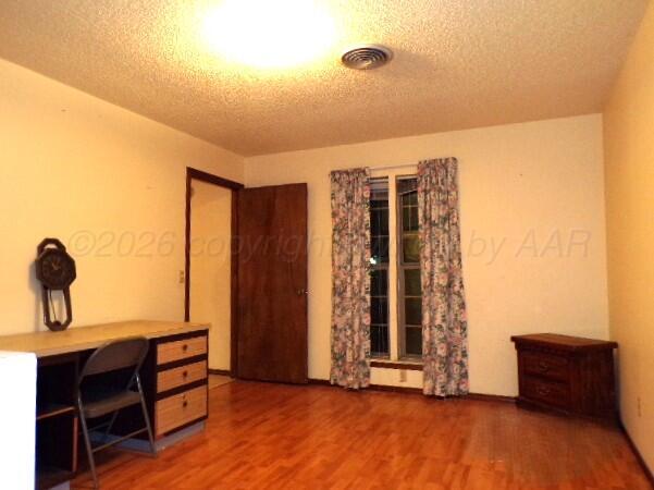 1620 Bluebell Street Amarillo, TX 79107 - Photo 14 of 28 a view of a room with wooden floor and furniture