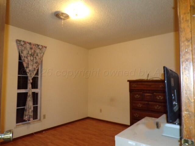 1620 Bluebell Street Amarillo, TX 79107 - Photo 16 of 28 a view of an empty room and wooden floor